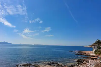 a view of the ocean from a rocky beach at Naiads Nest - The Cozy Retreat in Varkiza
