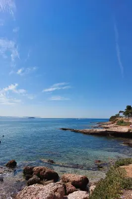 a view of the ocean with rocks in the water at Naiads Nest - The Cozy Retreat in Varkiza