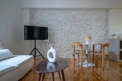 a living room with a couch and a table with chairs at Cream in Athens