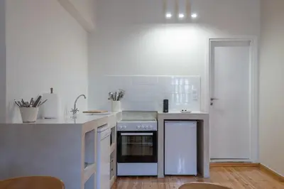 a kitchen with a stove and a counter top at Cream in Athens