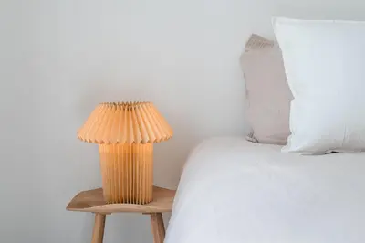 a lamp sitting on a table next to a bed at Bill in Athens