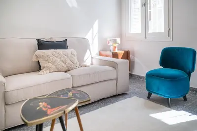 a living room with a couch and a blue chair at Bill in Athens
