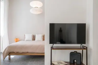 a bedroom with a bed and a flat screen tv at Bill in Athens