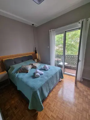 a bedroom with a bed with towels on it at Piraeus open view Appartment in Piraeus