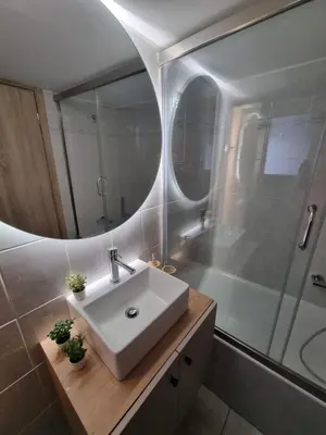 a bathroom with a sink and a shower at Piraeus open view Appartment in Piraeus