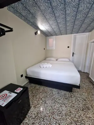 a bedroom with a bed with a blue patterned ceiling at 7ATHENS in Athens