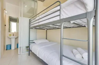a bedroom with two bunk beds and a sink at 7ATHENS in Athens