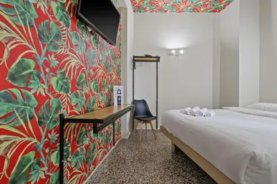 a bedroom with a bed and a red and green wall at 7ATHENS in Athens