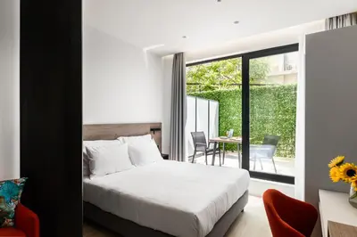 a bedroom with a bed and a balcony at Hestia - Averof 7 in Athens