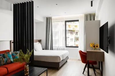 a hotel room with a bed and a couch at Hestia - Averof 7 in Athens
