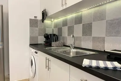 a kitchen with a sink and a microwave at Pame Rentals - Ideal For 4 in Pagrati in Athens