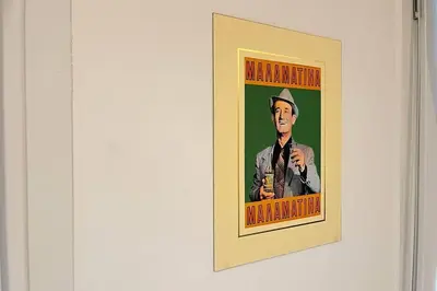 a picture of a man holding a microphone on a wall at Pame Rentals - Ideal For 4 in Pagrati in Athens