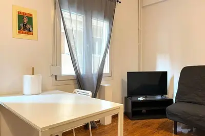 a living room with a couch and a television at Pame Rentals - Ideal For 4 in Pagrati in Athens