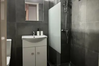a bathroom with a sink and a shower at Pame Rentals - Ideal For 4 in Pagrati in Athens