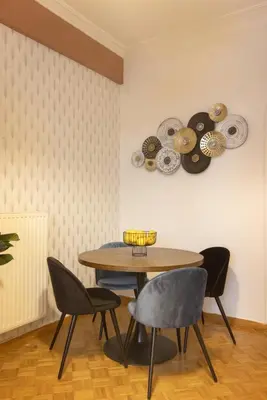 a dining room with a table and four chairs at Pausaniou8 in Athens