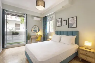 a bedroom with a large bed and a window at Pausaniou8 in Athens