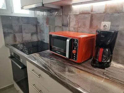 a microwave sitting on top of a kitchen counter at Marina Zeas Hidden Gem in Piraeus