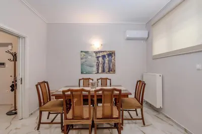a dining room with a table and chairs at Marina Zeas Hidden Gem in Piraeus