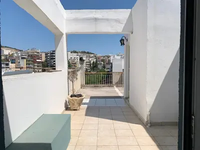 a balcony with a bench and a view of a city at Athenian Sky in Athens