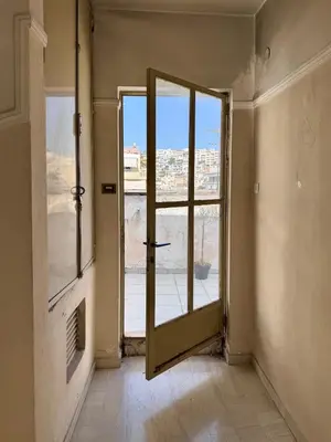 an empty room with a door and a window at Athenian Sky in Athens