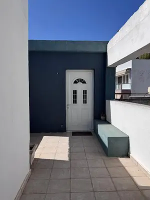 a building with a white door and a blue wall at Athenian Sky in Athens