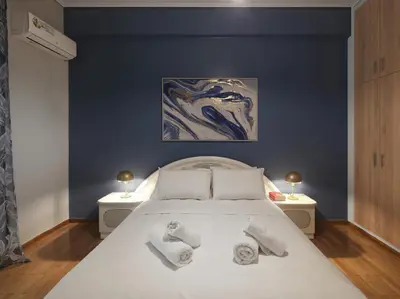 a bedroom with a white bed with two night stands at Comfortable apartment next to Museum and park in Athens