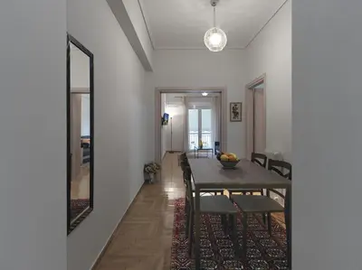 a dining room with a table and a mirror at Comfortable apartment next to Museum and park in Athens