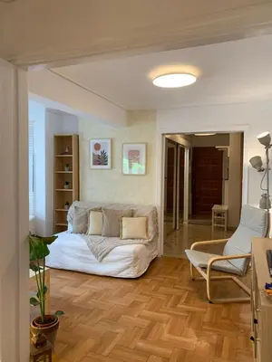 a living room with a bed and a couch at Chic Urban Living: Apartment in Acropolis-Koukaki in Athens