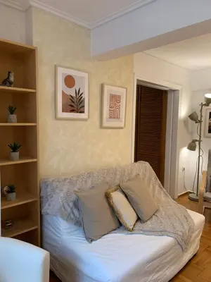 a living room with a couch with pillows on it at Chic Urban Living: Apartment in Acropolis-Koukaki in Athens