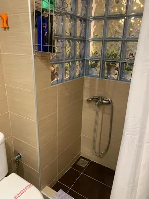 a shower with a glass door in a bathroom at Chic Urban Living: Apartment in Acropolis-Koukaki in Athens