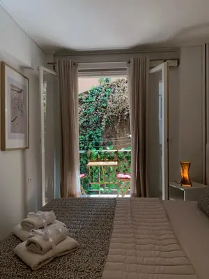 a bedroom with a large bed with towels on it at Chic Urban Living: Apartment in Acropolis-Koukaki in Athens
