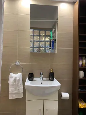 a bathroom with a sink and a mirror at Chic Urban Living: Apartment in Acropolis-Koukaki in Athens
