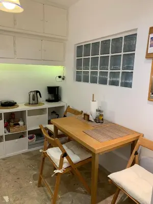 a kitchen with a wooden table and chairs at Chic Urban Living: Apartment in Acropolis-Koukaki in Athens