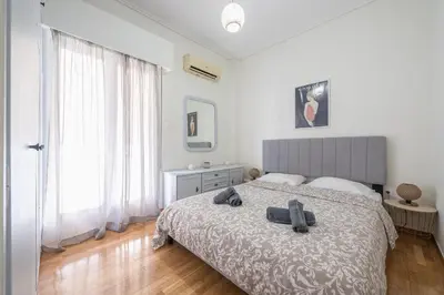 a bedroom with a bed with two towels on it at Virona 2nd Floor Greece Apartments in Athens