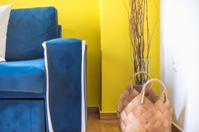 a living room with a blue couch and two baskets at Virona 2nd Floor Greece Apartments in Athens