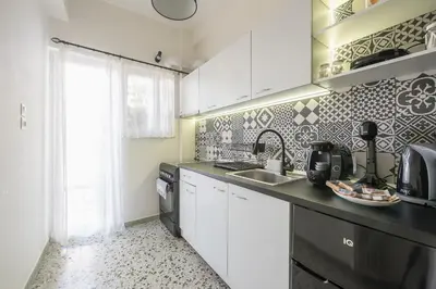 a kitchen with white cabinets and a sink at Virona 2nd Floor Greece Apartments in Athens
