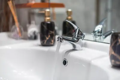 a sink with a faucet and two bottles of soap at Virona 2nd Floor Greece Apartments in Athens