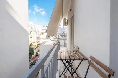 a balcony with a bench and a view of a city at Virona 2nd Floor Greece Apartments in Athens