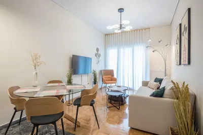 a living room with a table and a couch at The Luxury Suite by Cloudkeys in Athens