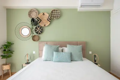 a bedroom with a large white bed with blue pillows at The Luxury Suite by Cloudkeys in Athens