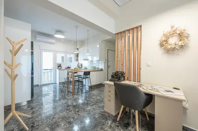 a kitchen with a desk and chairs in a room at The Luxury Suite by Cloudkeys in Athens
