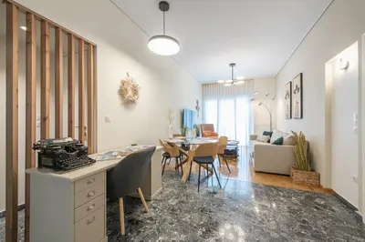 a living room with a table and a dining room at The Luxury Suite by Cloudkeys in Athens