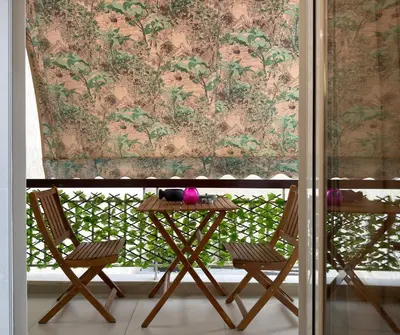 a table and two chairs on a balcony at 'Η Ωραία των Αθηνών' A Lux & Cozy Apt in Athens in Athens