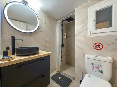 a bathroom with a toilet and a sink and a mirror at 'Η Ωραία των Αθηνών' A Lux & Cozy Apt in Athens in Athens