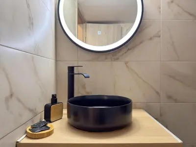 a black sink in a bathroom with a mirror at 'Η Ωραία των Αθηνών' A Lux & Cozy Apt in Athens in Athens