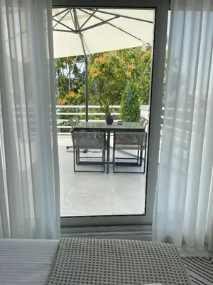 a bedroom with a patio with a table and an umbrella at URBAN SUITES ATHENS in Athens