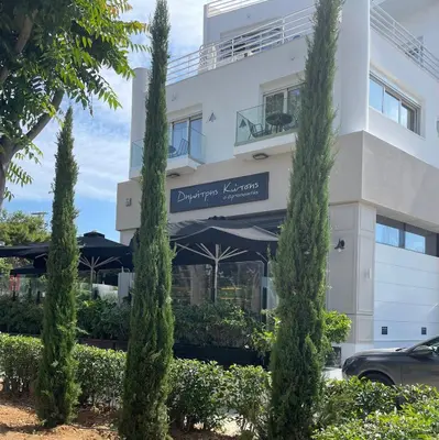 a building with trees in front of it at URBAN SUITES ATHENS in Athens
