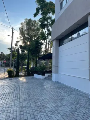 a brick sidewalk next to a white building at URBAN SUITES ATHENS in Athens