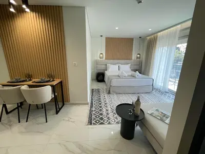 a hotel room with a bed and a table at URBAN SUITES ATHENS in Athens