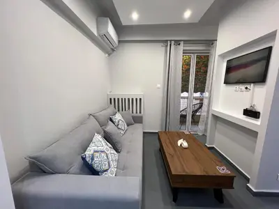 a living room with a couch and a coffee table at The island studio in Piraeus